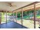 Screened-in porch with a ceiling fan overlooks a spacious backyard with a wooden fence at 4925 Seacroft Rd, Charlotte, NC 28210