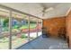 Covered porch with brick accent wall and ceiling fan offers a relaxing outdoor space at 4925 Seacroft Rd, Charlotte, NC 28210