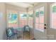 Charming sunroom with brick accent wall, tile floors, and several windows looking out to a garden at 4925 Seacroft Rd, Charlotte, NC 28210