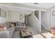 Spacious basement area perfect for entertaining, complete with comfortable seating and neutral carpet at 7324 Pebblestone Dr # E, Charlotte, NC 28212