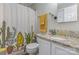 Bright bathroom with a shower featuring a fun cactus themed curtain, modern vanity and granite countertop at 7324 Pebblestone Dr # E, Charlotte, NC 28212