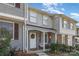 Charming two-story townhouse featuring a cozy front porch and decorative wreath on the front door at 7324 Pebblestone Dr # E, Charlotte, NC 28212