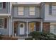 Charming two-story townhouse featuring a cozy front porch and decorative wreath on the front door at 7324 Pebblestone Dr # E, Charlotte, NC 28212