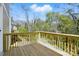 An empty wooden deck with wooden railings overlooks a wooded backyard at 74 Snyder Ne Ct, Concord, NC 28025