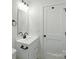 Bathroom with white vanity, black hardware, and an illuminated mirror at 74 Snyder Ne Ct, Concord, NC 28025