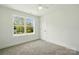 Bedroom featuring a ceiling fan, a window, and gray carpeting at 74 Snyder Ne Ct, Concord, NC 28025