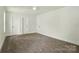 Spacious carpeted bedroom with two doors and large windows at 74 Snyder Ne Ct, Concord, NC 28025