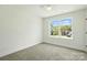 Bedroom with gray carpet, a ceiling fan, and a bright window at 74 Snyder Ne Ct, Concord, NC 28025