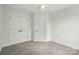A bedroom with neutral carpeting, a ceiling fan, and a closet at 74 Snyder Ne Ct, Concord, NC 28025
