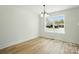 Dining room with new hardwood floors, and a view of the lawn through the large window at 74 Snyder Ne Ct, Concord, NC 28025
