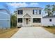 Charming two-story home showcasing neutral siding, black shutters, and a well-manicured front yard at 74 Snyder Ne Ct, Concord, NC 28025