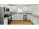 Modern kitchen featuring white cabinets, stainless steel appliances, and gray countertops at 74 Snyder Ne Ct, Concord, NC 28025