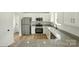Bright kitchen featuring stainless steel appliances, granite countertops, and white cabinets at 74 Snyder Ne Ct, Concord, NC 28025