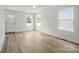 Bright living room featuring wood-look floors, fresh white paint and multiple windows at 74 Snyder Ne Ct, Concord, NC 28025