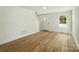 Bright living room featuring wood-look floors, fresh white paint and a large window at 74 Snyder Ne Ct, Concord, NC 28025