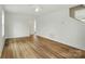 Spacious living room with wood-look flooring, ceiling fan, and ample natural light at 74 Snyder Ne Ct, Concord, NC 28025