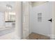 Walk-in shower featuring white subway tile, a shower niche, and a bronze shower head at 7600 Brookmont Ln, Waxhaw, NC 28173