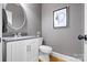 Modern bathroom featuring a vanity with a gray countertop, decorative art, and tile flooring at 7600 Brookmont Ln, Waxhaw, NC 28173
