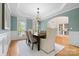 Elegant dining room with wainscoting, chandelier, and a view into the foyer at 7600 Brookmont Ln, Waxhaw, NC 28173