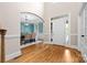 Bright foyer featuring hardwood floors, a dining room view, and white trim at 7600 Brookmont Ln, Waxhaw, NC 28173