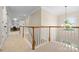 Well-lit hallway featuring a built-in desk and elegant chandelier at 7600 Brookmont Ln, Waxhaw, NC 28173