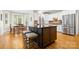 Kitchen with a large kitchen island with bar stool seating and stainless steel appliances at 7600 Brookmont Ln, Waxhaw, NC 28173