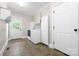 Bright laundry room featuring a washer, dryer, tile floors, and storage cabinets at 7600 Brookmont Ln, Waxhaw, NC 28173