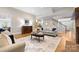 Cozy living room with hardwood floors, neutral tones, and comfortable seating area at 7600 Brookmont Ln, Waxhaw, NC 28173