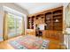 Home office featuring custom built-in shelving, desk area, and large window with natural light at 7600 Brookmont Ln, Waxhaw, NC 28173