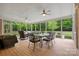 Relaxing screened porch with ceiling fans and outdoor dining area at 7600 Brookmont Ln, Waxhaw, NC 28173
