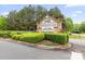Elegant stone sign for Weddington Chase, set among manicured hedges and trees at 7600 Brookmont Ln, Waxhaw, NC 28173