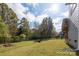 Large backyard, enclosed with a metal fence, with seating around a fire pit at 8419 Everwood Ave, Huntersville, NC 28078