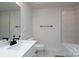 Minimalist bathroom with modern fixtures, including a tub and vanity at 8419 Everwood Ave, Huntersville, NC 28078