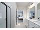 Bright bathroom featuring double vanity, sleek black fixtures, and a glass-enclosed shower at 8419 Everwood Ave, Huntersville, NC 28078