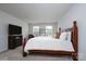 Inviting bedroom with a classic wood bed and soft, neutral decor at 8419 Everwood Ave, Huntersville, NC 28078
