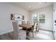 Bright dining room with a wooden table, beige upholstered chairs, modern decor and hardwood floors at 8419 Everwood Ave, Huntersville, NC 28078