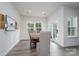 Bright dining room with a wooden table, grey upholstered chairs, modern decor and hardwood floors at 8419 Everwood Ave, Huntersville, NC 28078