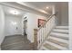 Inviting foyer with wood-look floors, staircase, and front door featuring glass accents at 8419 Everwood Ave, Huntersville, NC 28078
