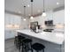 Modern kitchen with white cabinets, stainless steel appliances, and a center island with seating at 8419 Everwood Ave, Huntersville, NC 28078