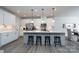 Open kitchen featuring a large island with seating, stainless steel appliances, and white cabinetry at 8419 Everwood Ave, Huntersville, NC 28078