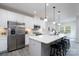 Bright kitchen featuring a large island with seating, stainless steel appliances and white cabinetry at 8419 Everwood Ave, Huntersville, NC 28078
