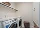 Efficient laundry room setup with front-load washer/dryer and ample counter space at 8419 Everwood Ave, Huntersville, NC 28078