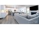 Open-concept living space with a modern kitchen, fireplace, and dining area at 8419 Everwood Ave, Huntersville, NC 28078
