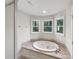 Bathroom with jacuzzi tub and natural light at 845 Creek Bluff Rd, Rock Hill, SC 29732