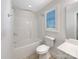 Clean, white bathroom with a shower and bathtub combo, bright lighting, and essential fixtures at 845 Creek Bluff Rd, Rock Hill, SC 29732