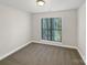 This bedroom has a window that is equipped with blinds and neutral-colored carpeting at 845 Creek Bluff Rd, Rock Hill, SC 29732