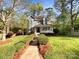 Two-story home with front porch surrounded by a lush landscaped yard at 845 Creek Bluff Rd, Rock Hill, SC 29732