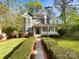 Charming two-story home with blue siding, a welcoming front porch, and meticulously manicured landscaping at 845 Creek Bluff Rd, Rock Hill, SC 29732