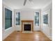Bright living room featuring a fireplace, hardwood floors, and natural light from large windows at 845 Creek Bluff Rd, Rock Hill, SC 29732