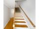 Open staircase with wooden railing that connects to the upper level at 845 Creek Bluff Rd, Rock Hill, SC 29732